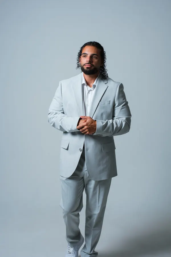 Ajay in a light grey suit