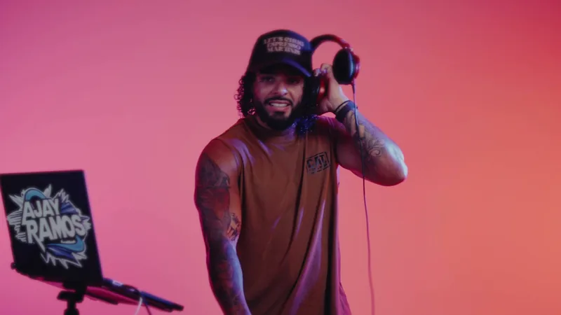DJ Ajay Ramos smiling with headphones on
