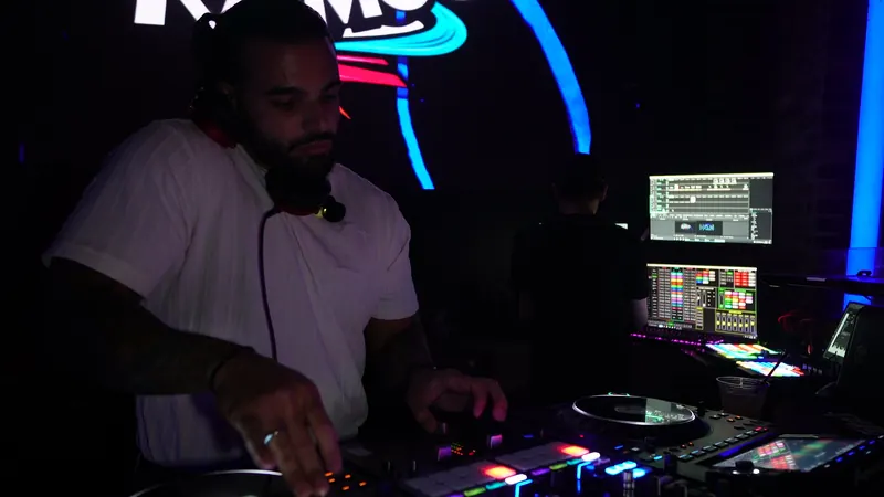 Boston club DJ Ajay Ramos on the decks under neon