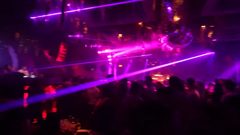 Purple lasers over a packed club floor during an Ajay Ramos set