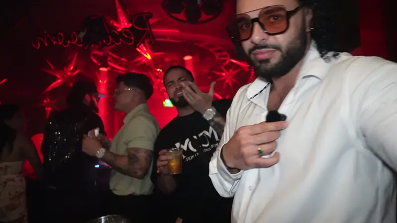 Ajay in the middle of a red-lit club crowd