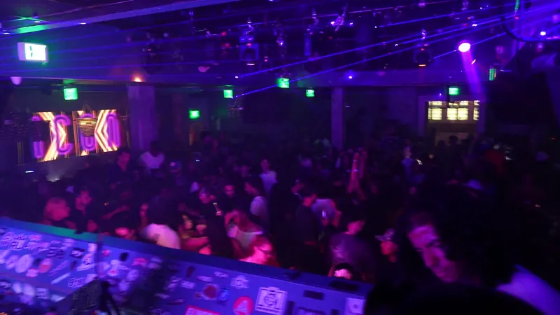 A packed club seen from the DJ booth