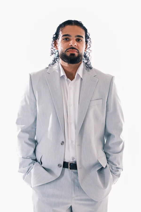 Wedding DJ Ajay Ramos in a light grey suit