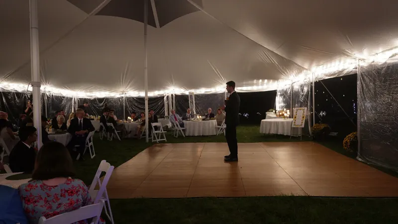 A Massachusetts wedding reception under string lights after dark