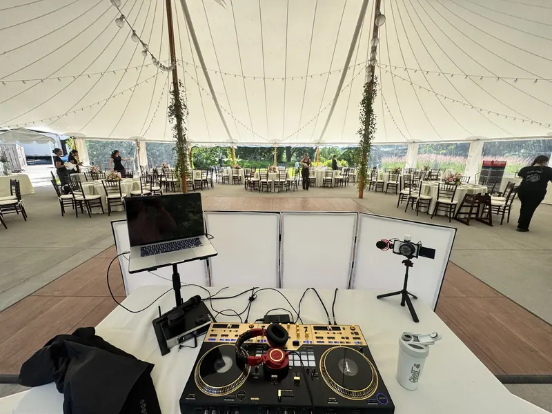 Ajay's wedding DJ setup overlooking a tent full of reception tables