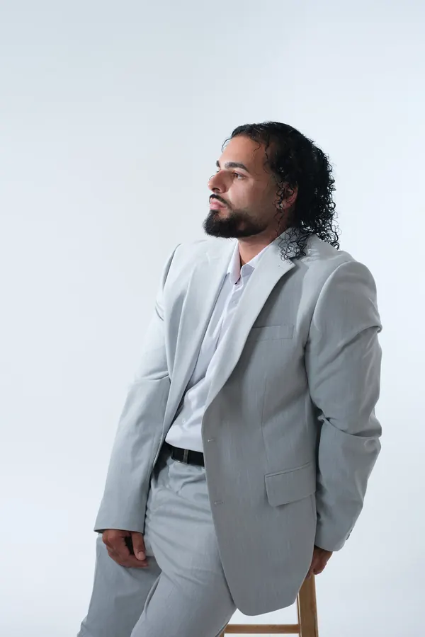 Wedding DJ Ajay Ramos in a light grey suit